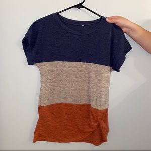 womens blue, brown, and orange t shirt with a tie.